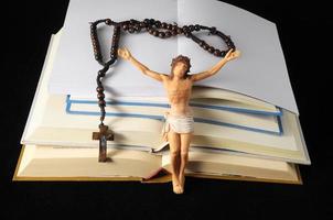 Jesus and books on dark background photo