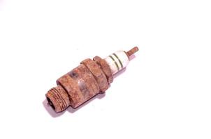 Rusty plug on light background photo