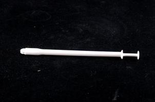Syringe on dark background photo