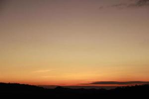 sunrise sunset sky with clouds over the mountain view background photo