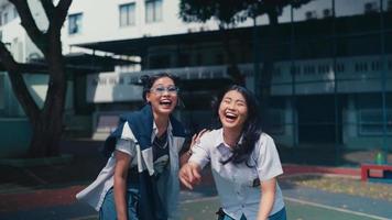 two female students laugh at their friend who gets bullied at school video