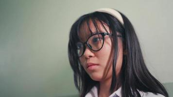 an Asian woman is checking social media on her smart phone during recess video