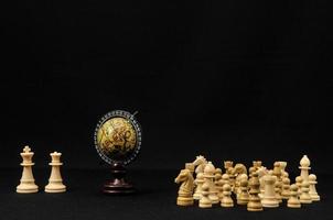 Chess pieces and globe photo