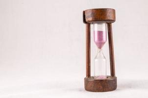 Hourglass on light background photo