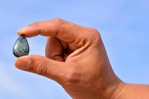 Hand holding a gemstone photo