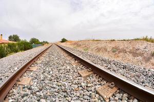 Railroad tracks on gravel photo