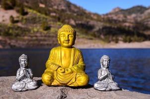 Buddha statue on the rock photo