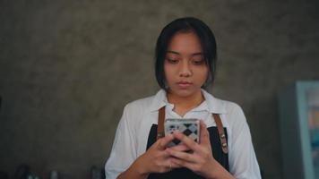 a woman holding a smart phone with a sad expression video