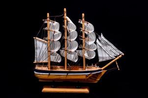 Wooden ship on dark background photo
