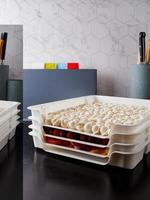 Smart storage of frozen food in trays. Dumplings, berries, peppers are convenient to prepare for the winter photo