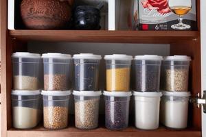 Organization of food storage in the kitchen, transparent reusable jars for cereals, coffee, sugar and pasta photo