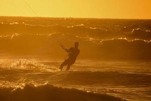 kitesurfer a puesta de sol foto