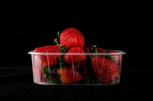 Strawberries on black background photo