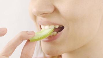 Woman eating dried apple in close-up. Dry fruits. Close-up woman eats dried green apple. video