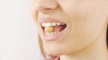 Close-up woman eats nuts and dried fruit. Woman eating nuts in close-up. video