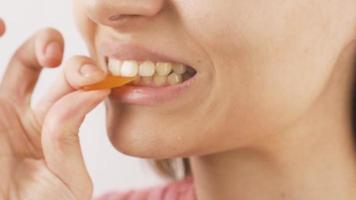 Close-up of woman eating jelly beans. Close-up of woman eating jelly beans. video