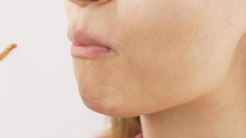 Close-up portrait of woman eating cracker. Close-up portrait of woman eating cracker. video