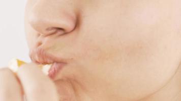 Close-up of woman eating tangerine. Close-up mouth of woman eating tangerine. video