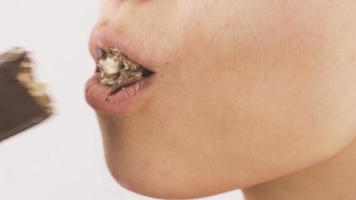 Close-up of woman eating wafer. Eating chocolate. Close-up of woman eating wafer. video