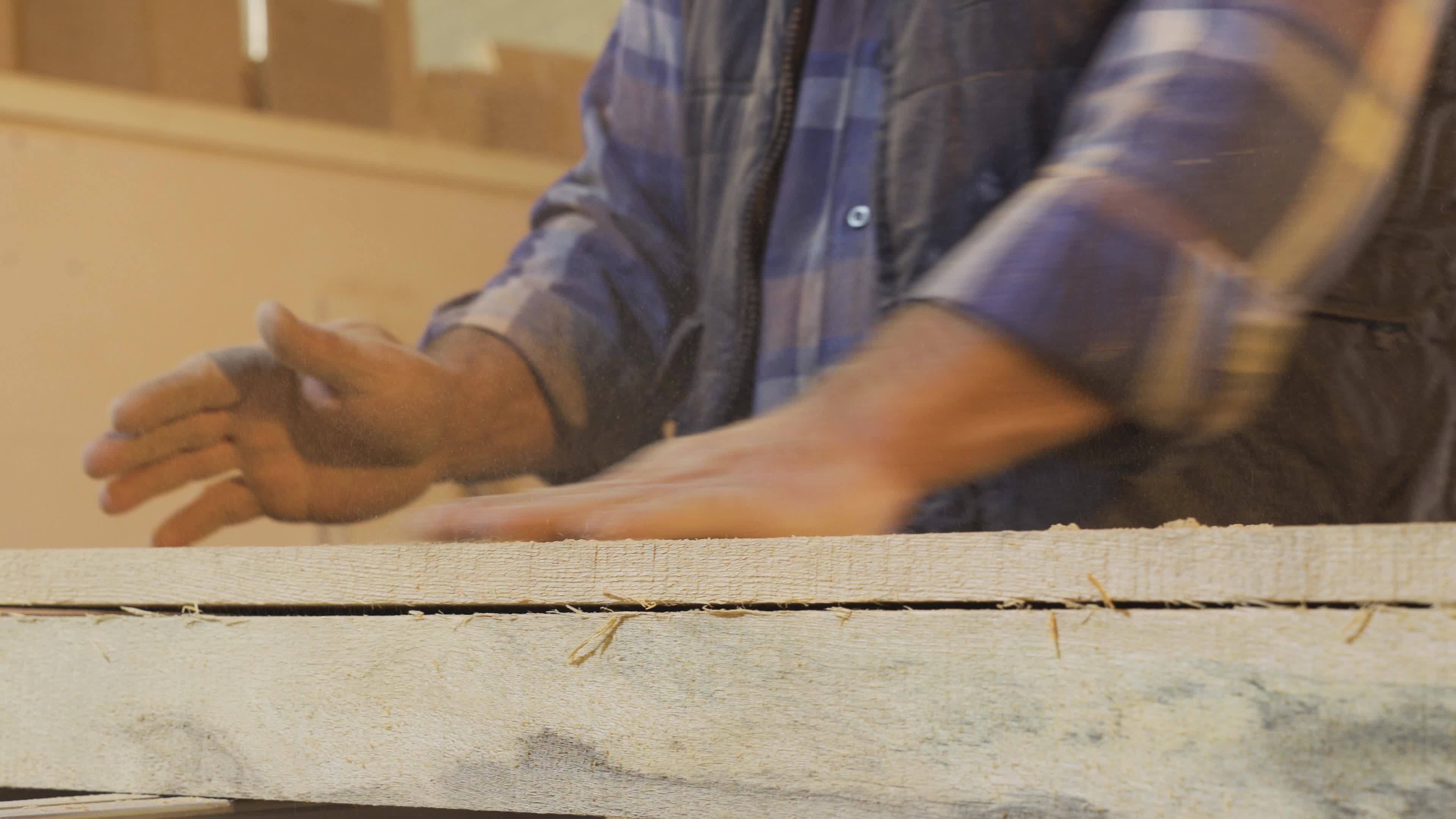 Carpenter man clapping and cleaning his dusty and sawdust hands
