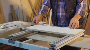 The carpenter measures the wood with the meter and marks it with a pencil. Close-up wooden measure. The carpenter is measuring with the meter. video