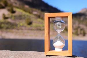 Sand hourglass. Concept of time. photo