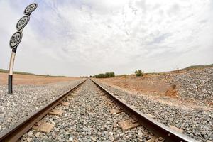 Train tracks over gravel photo