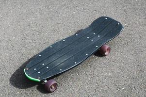 Skateboard on sidewalk photo