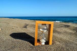 Hourglass in the sand photo