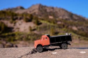 Toy truck on a rock photo