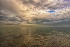 Exciting sea landscape. Beautiful colorful clouds over the calm sea. photo