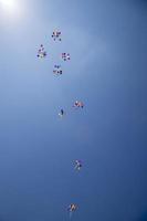 The multi colored helium balloons flying In the blue sky. the concept of a wedding, celebration, anniversary, entertainment photo