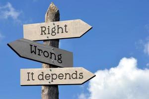 Right, Wrong, it Depends - Wooden Signpost with Three Arrows, Sky with Clouds photo