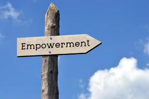 Empowerment - Wooden Signpost with one Arrow, Sky with Clouds photo