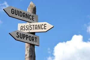 Guidance, Assistance, Support - Wooden Signpost with Three Arrows photo