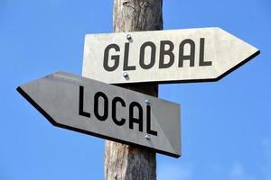 Global and Local - Wooden Signpost with Two Arrows photo