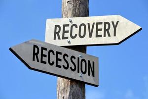 Recovery and Recession - Wooden Signpost with Two Arrows photo