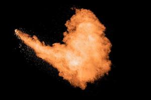 Orange powder explosion on white background. photo