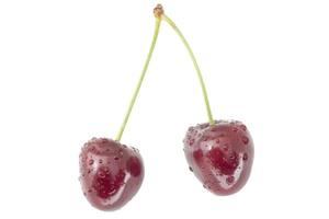 couple of wet red cherries isolated on white