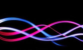 neon wavy line on black background, 3d render led light strips pink and blue photo