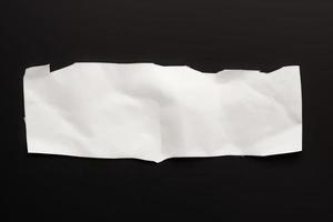 torn white paper on the black background, empty tet space background photo