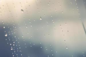 small water drop on the glass window, minimalistic design backdrop with copy space photo