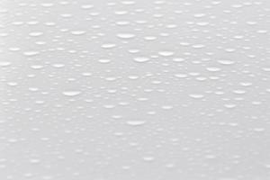 small water drop on the white backdrop, minimalistic design backdrop with copy space photo