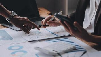 Financial analysts analyze business financial reports on a digital tablet planning investment project during a discussion at a meeting of corporate showing the results of their successful teamwork. video