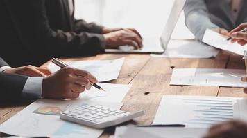 Financial analysts analyze business financial reports on a digital tablet planning investment project during a discussion at a meeting of corporate showing the results of their successful teamwork. video