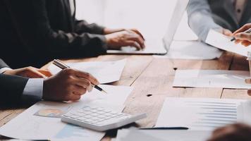 Group of confident business people point to graphs and charts to analyze market data, balance sheet, account, net profit to plan new sales strategies to increase production capacity. video
