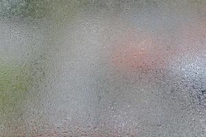 Glass with water vapor, fog, flow. a window with water drops. fogged glass photo