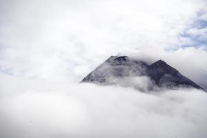 The dramatic view of Mount Merapi covered in clouds is very dense. Mountains that have the potential to erupt. photo