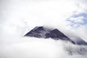 The dramatic view of Mount Merapi covered in clouds is very dense. Mountains that have the potential to erupt. photo