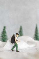 miniatura personas mochilero viaje en invierno hora foto